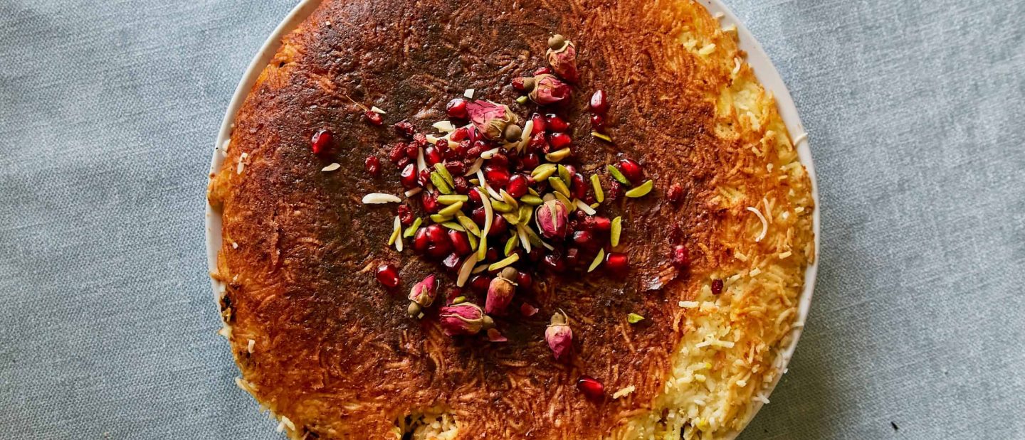 Baked rice topped with pistachios, rose petals and pomegranates from Wizzy’s Bapsang Cookbook