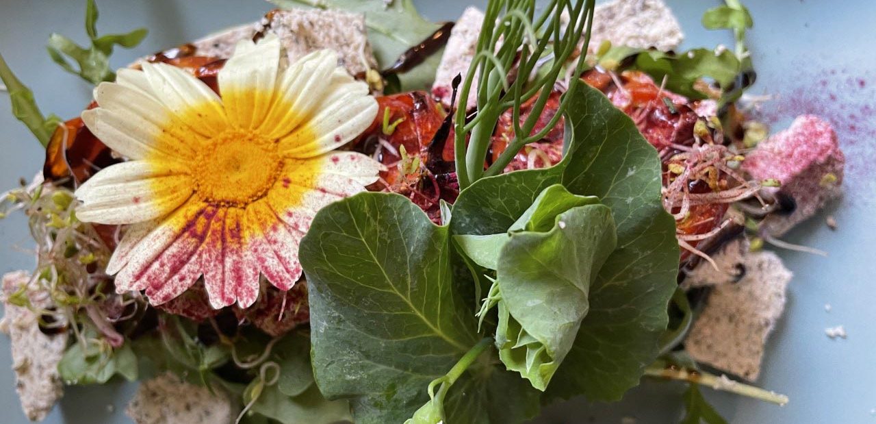 Plate of food decorated with flowers from Eat Your Greens